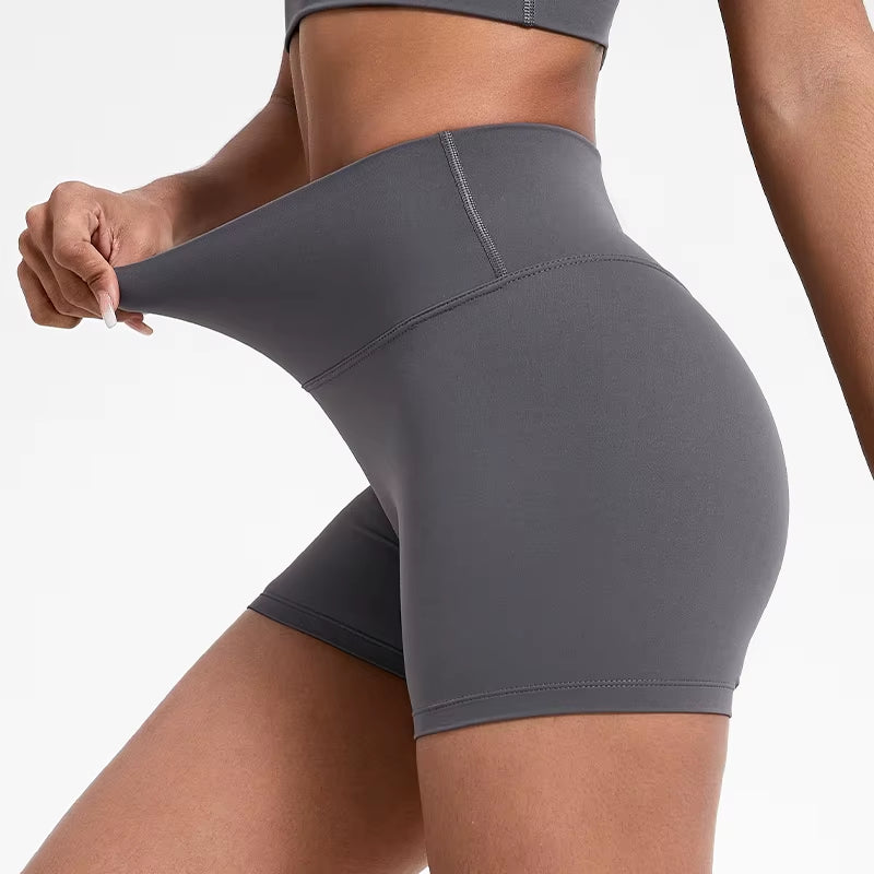 High-waisted sports shorts for women, designed to lift and shape, perfect for gym workouts, running, and fitness training. Made from soft, quick-drying fabric, these yoga shorts are ideal for comfortable and effective exercise.