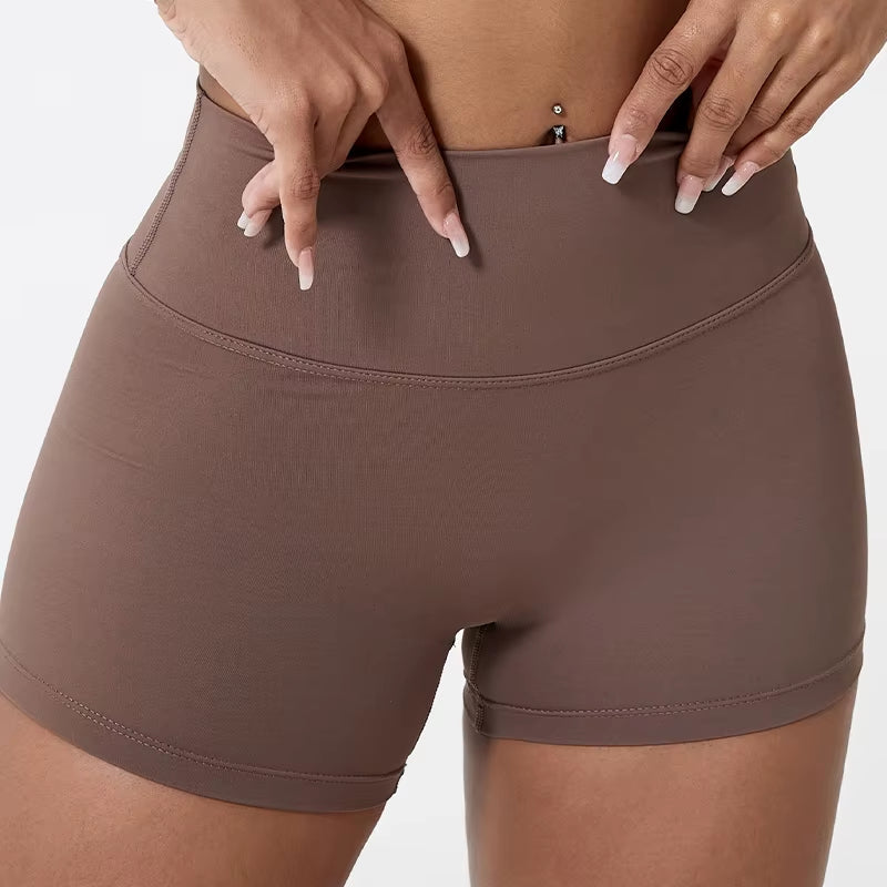High-waisted sports shorts for women, designed to lift and shape, perfect for gym workouts, running, and fitness training. Made from soft, quick-drying fabric, these yoga shorts are ideal for comfortable and effective exercise.