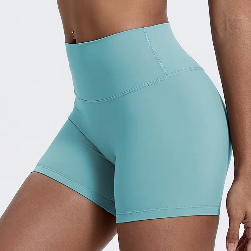High-waisted sports shorts for women, designed to lift and shape, perfect for gym workouts, running, and fitness training. Made from soft, quick-drying fabric, these yoga shorts are ideal for comfortable and effective exercise.