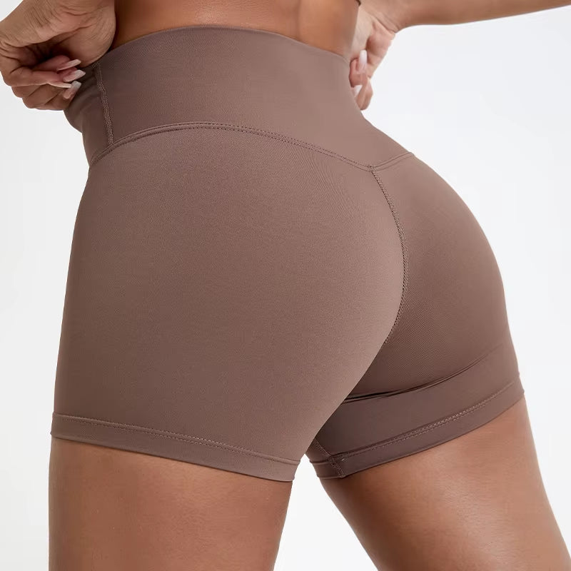 High-waisted sports shorts for women, designed to lift and shape, perfect for gym workouts, running, and fitness training. Made from soft, quick-drying fabric, these yoga shorts are ideal for comfortable and effective exercise.